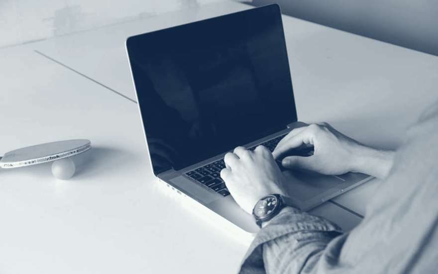 Writing a bid document on a laptop